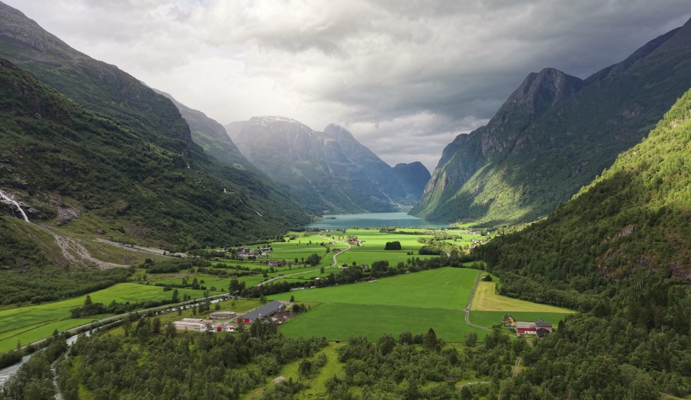 Valle verde y lago entre montañas en los fiordos noruegos